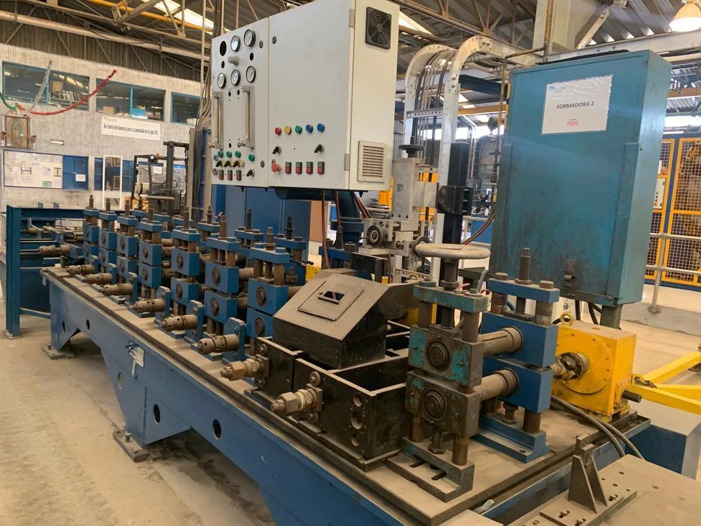 Rolling line with stands and roller tables carrying stock through the mill